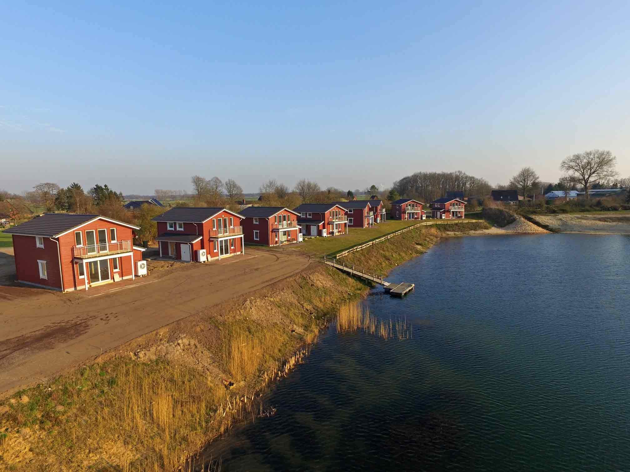 Foto von den Neubauten am Geestsee mit Steg zum Wasser.