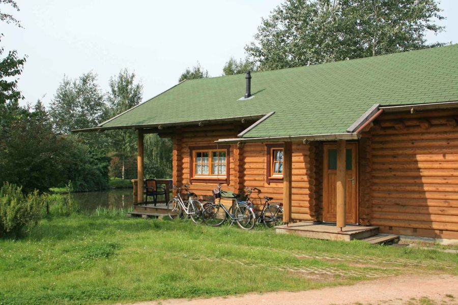 Foto eines Ferienhauses, vor dem Fahrräder abgestellt stehen. 