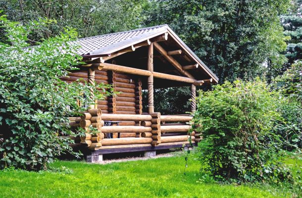 Typ C – Blockhaus 323 in Blockbohlenbauweise mit Geländer und überdachter Veranda